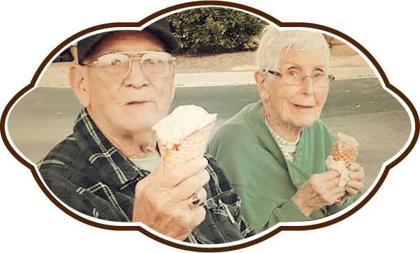 An elderly couple enjoying ice cream together, smiling and sharing a joyful moment